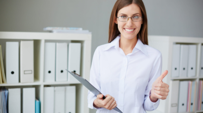 Young businesswoman with document showing thumb up