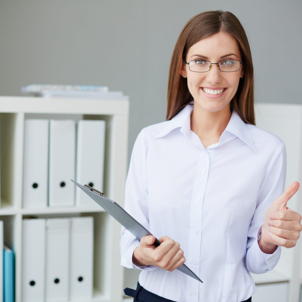 Young businesswoman with document showing thumb up